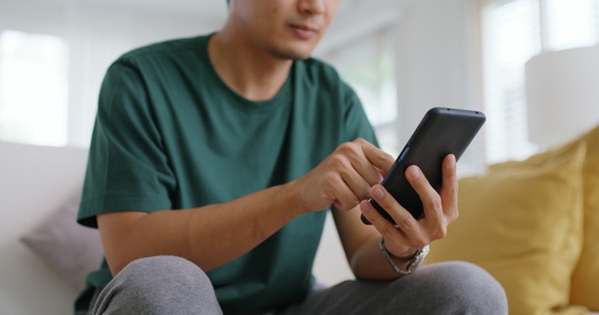 man scrolling on phone